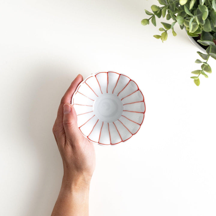 Scalloped edge condiment bowls, one with blue stripes and the other with red stripes