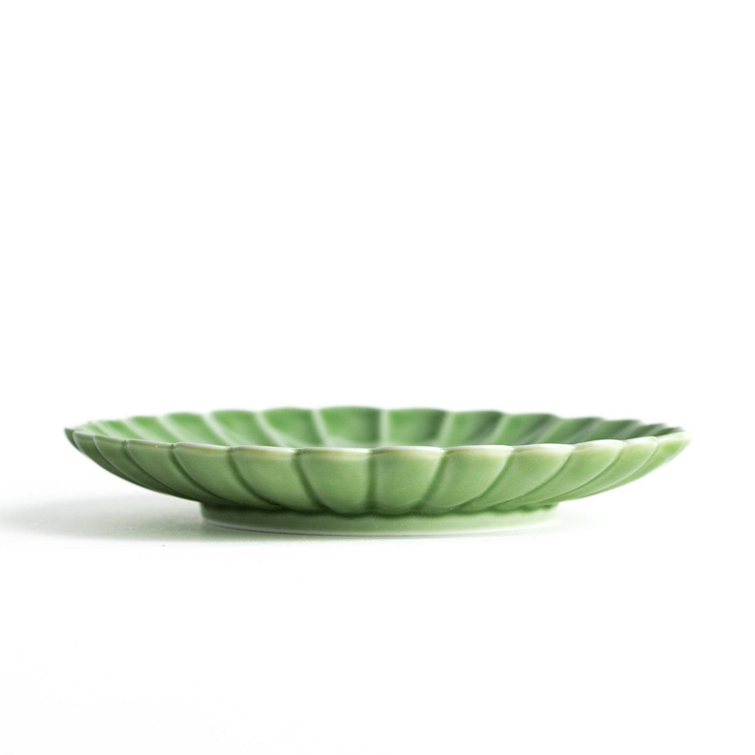 Small sauce dish in various colors (white, green, yellow) with scalloped edges.