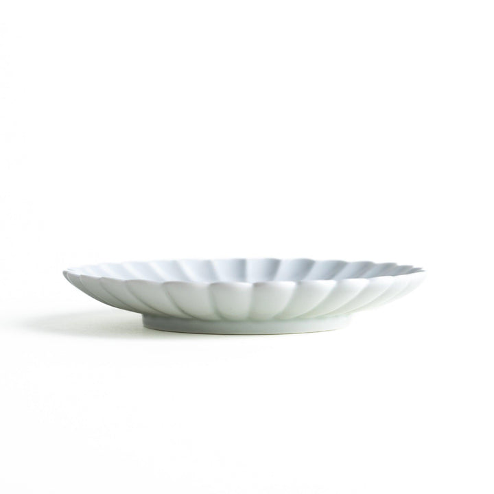 Small sauce dish in various colors (white, green, yellow) with scalloped edges.