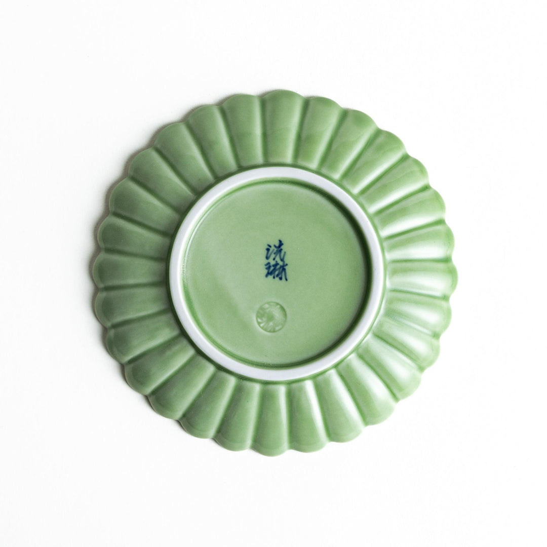 Small sauce dish in various colors (white, green, yellow) with scalloped edges.