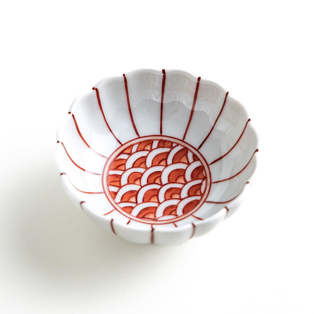 Small dessert bowls with scalloped edges, featuring a colorful inner pattern. Available in red or blue.