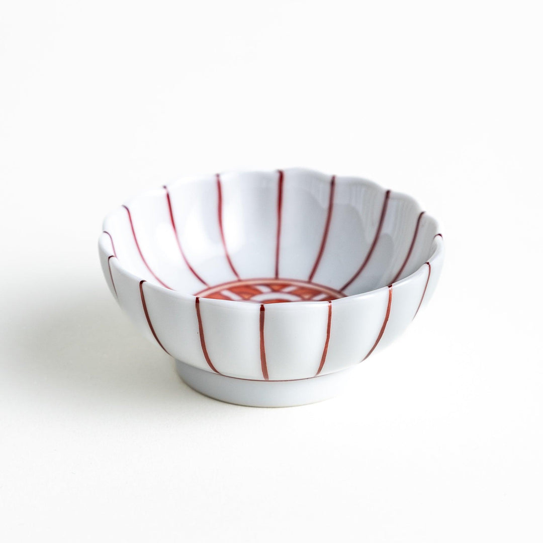 Small dessert bowls with scalloped edges, featuring a colorful inner pattern. Available in red or blue.