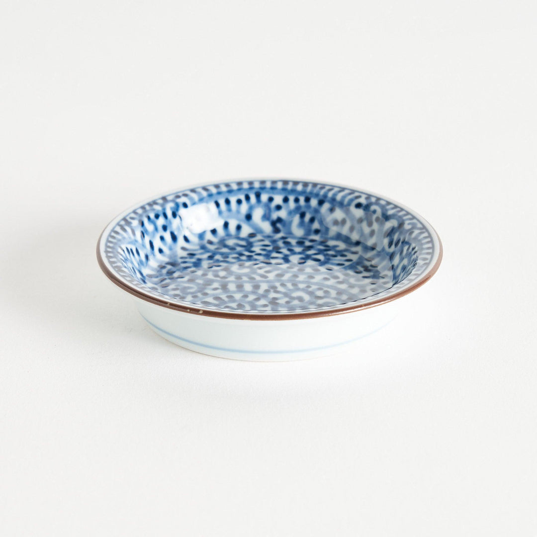 A round saucer with traditional blue floral patterns.