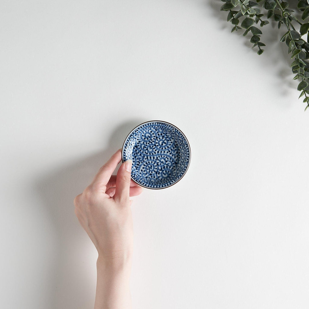 A round saucer with traditional blue floral patterns.