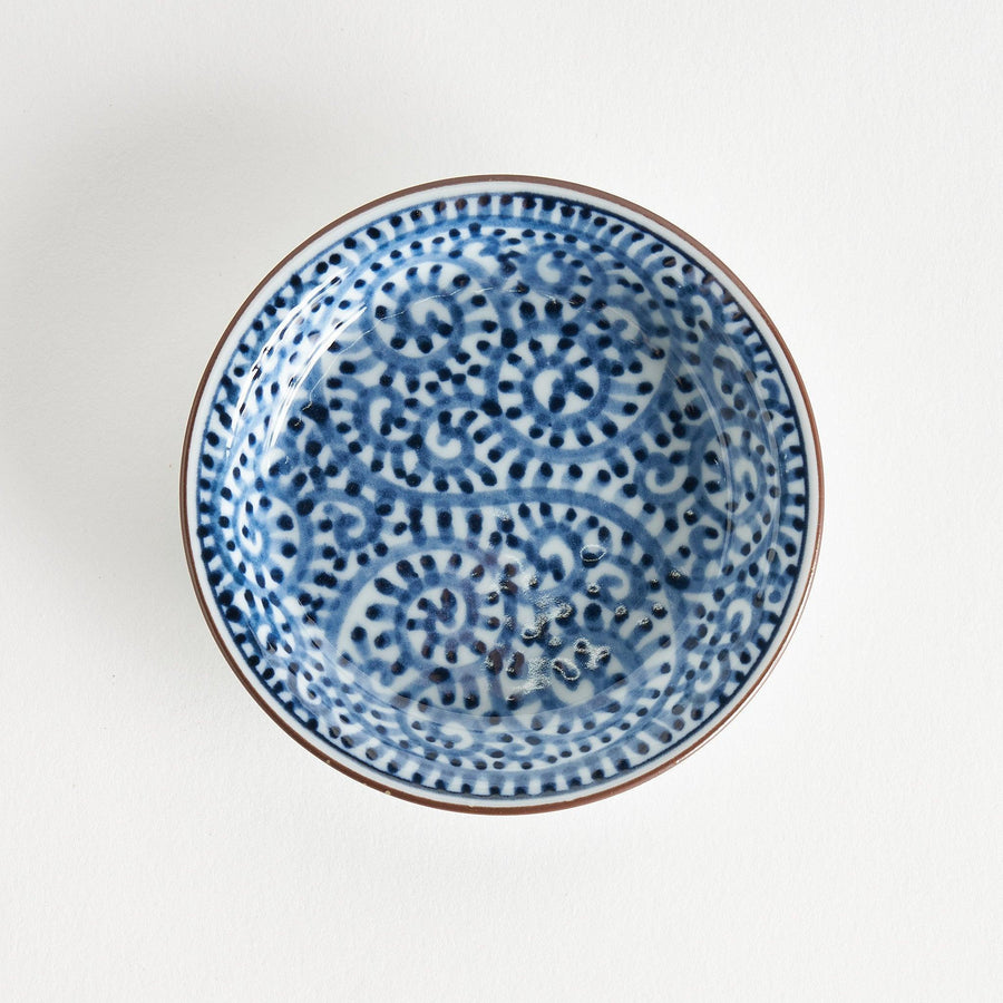 A round saucer with traditional blue floral patterns.