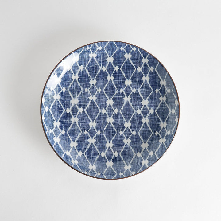 A round serving plate featuring a bold blue and white geometric lattice pattern, perfect for a contemporary table setting.