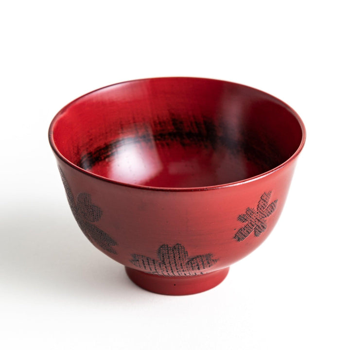 A lacquered bowl featuring a textured black floral design and a smooth, polished finish. Available in black or red.