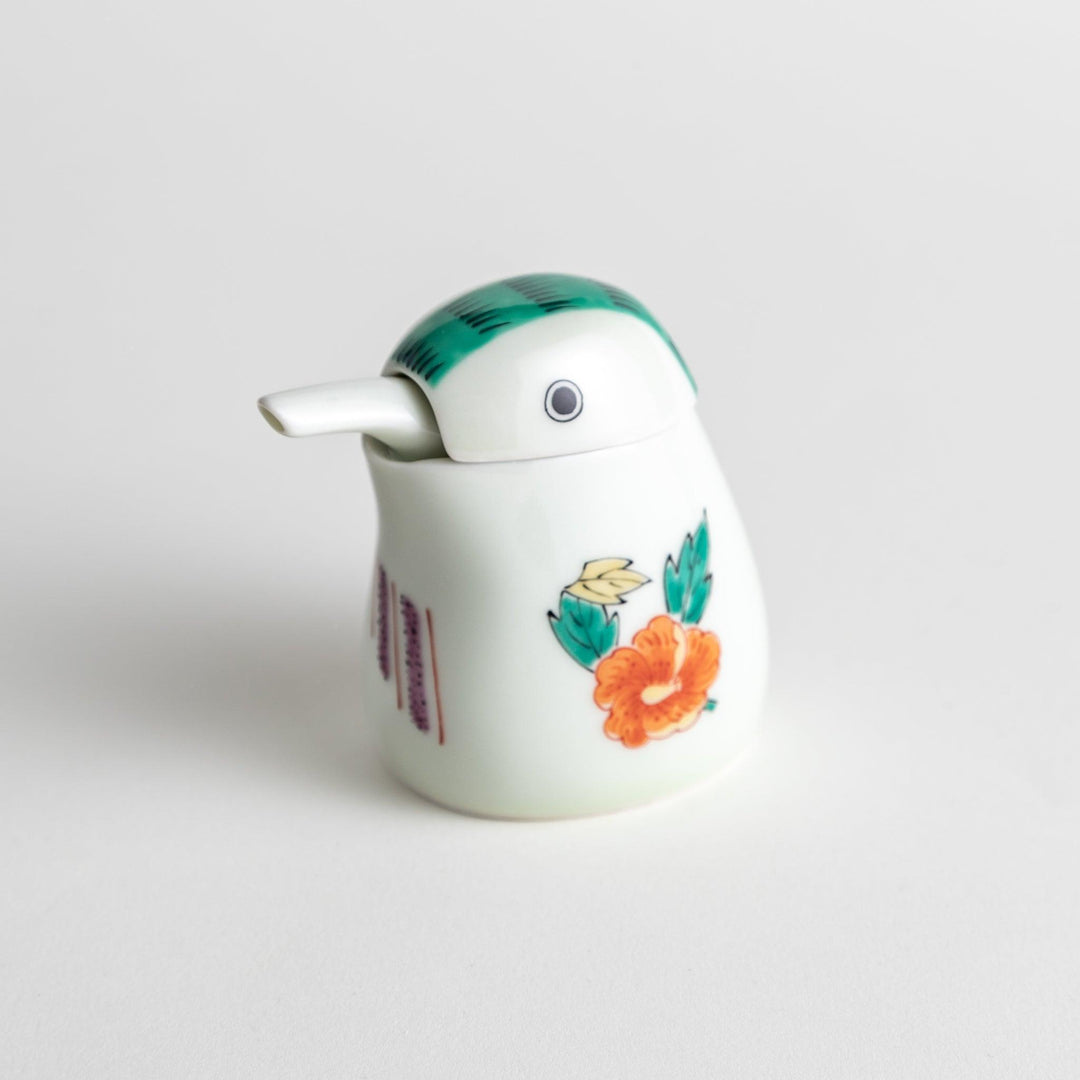 A bird-shaped soy sauce dispenser featuring a traditional floral design in red, green, and orange.