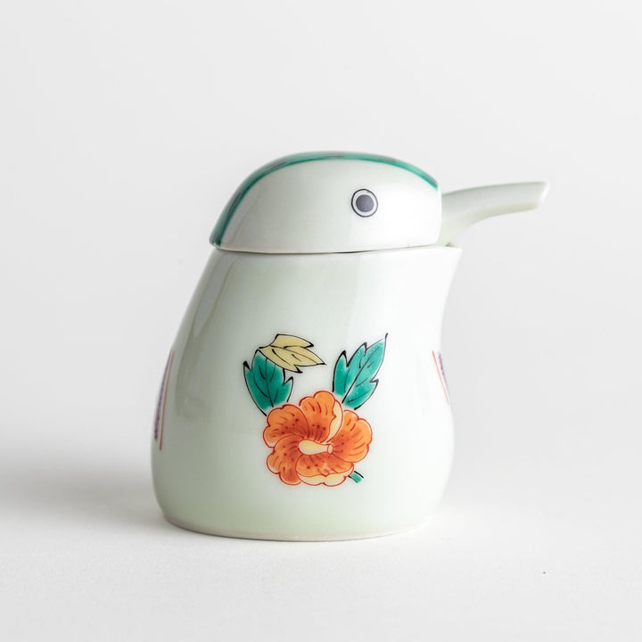 A bird-shaped soy sauce dispenser featuring a traditional floral design in red, green, and orange.