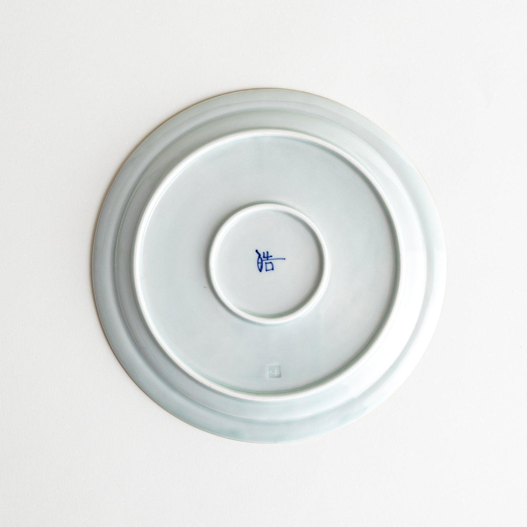 A small porcelain salad plate with a scalloped edge, decorated with blue and white floral motifs and brown accent trim.