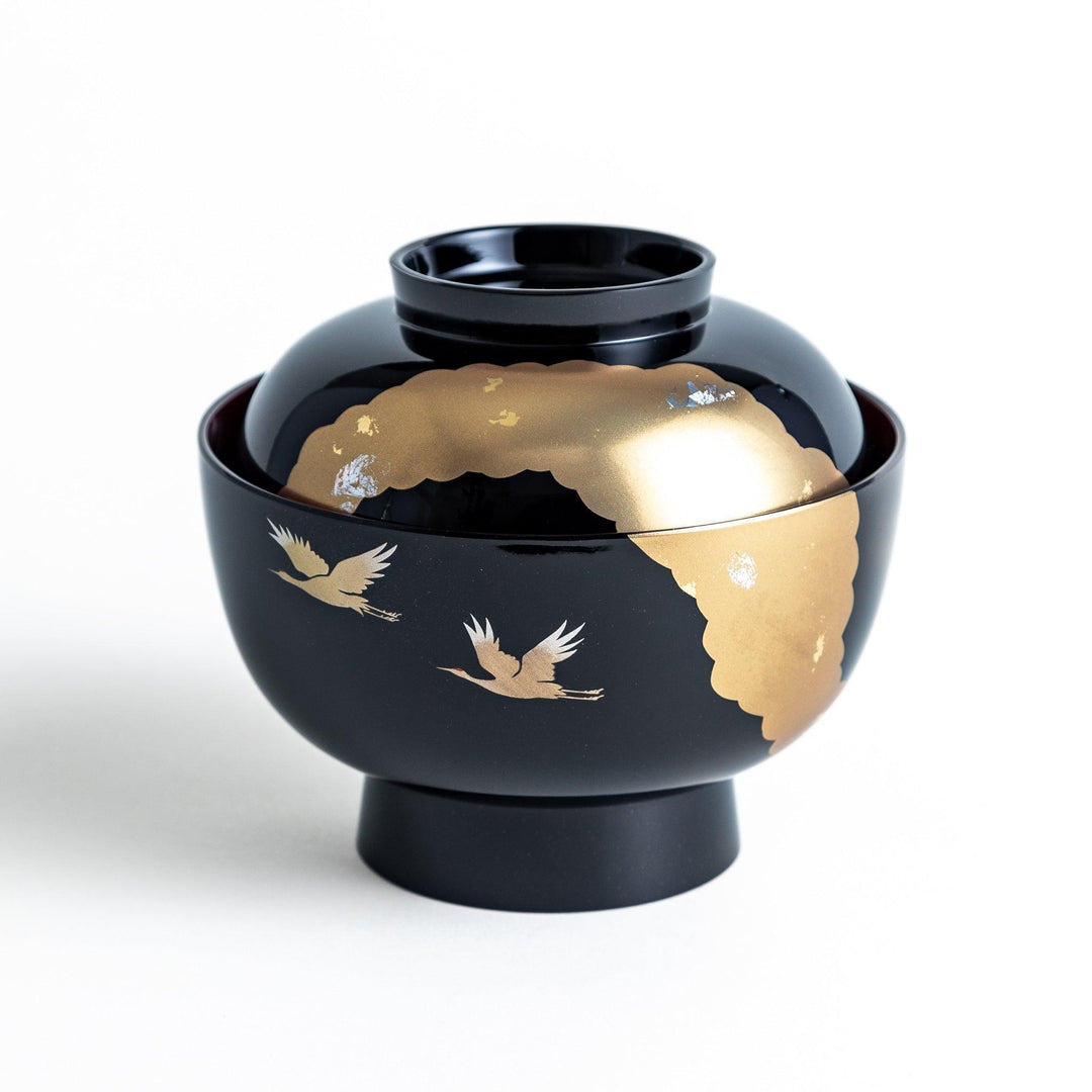 A lacquered soup bowl with a gold-painted cloud and crane motif. Available in red or black.