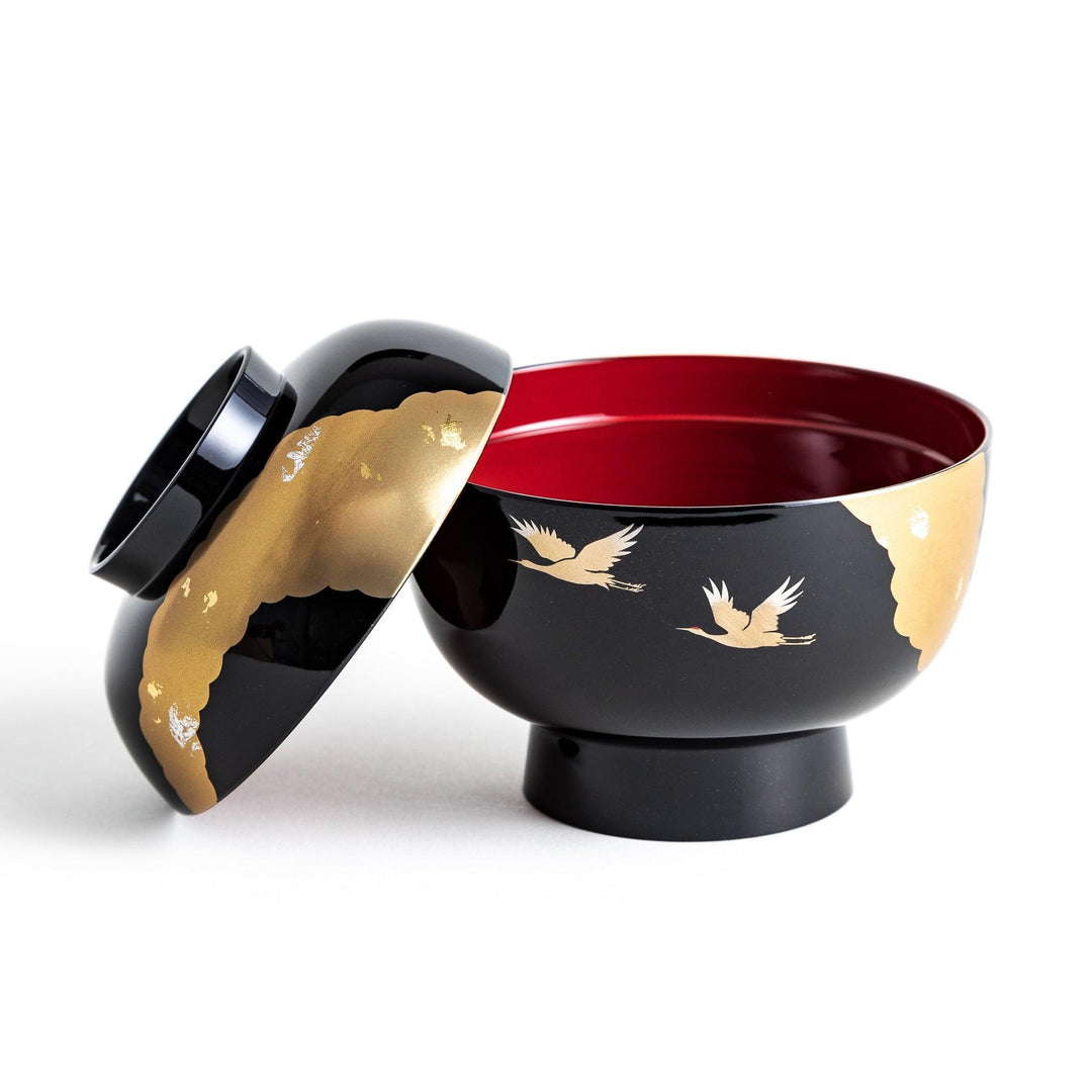 A lacquered soup bowl with a gold-painted cloud and crane motif. Available in red or black.