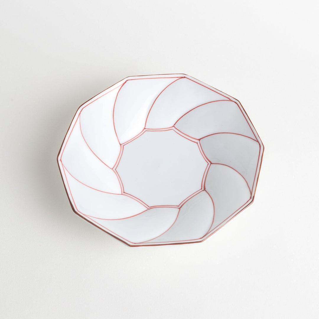 White luncheon plate with a petal design outlined in blue or red and bowl shape, featuring a subtle brown rim.