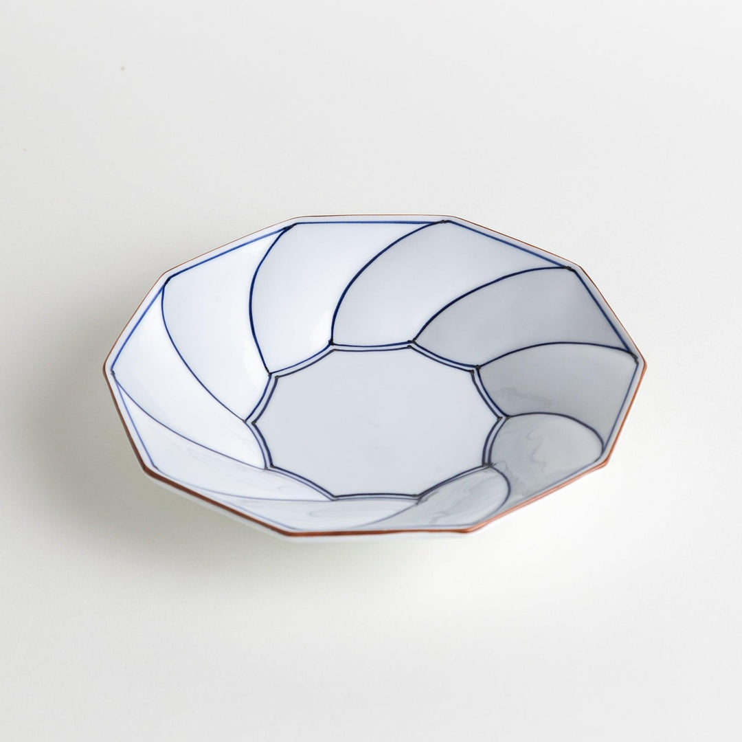 White luncheon plate with a petal design outlined in blue or red and bowl shape, featuring a subtle brown rim.