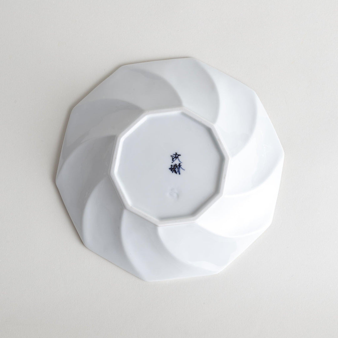 White luncheon plate with a petal design outlined in blue or red and bowl shape, featuring a subtle brown rim.