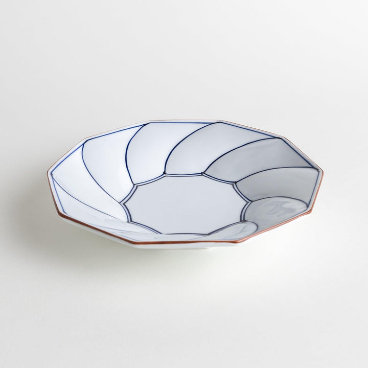 White luncheon plate with a petal design outlined in blue or red and bowl shape, featuring a subtle brown rim.