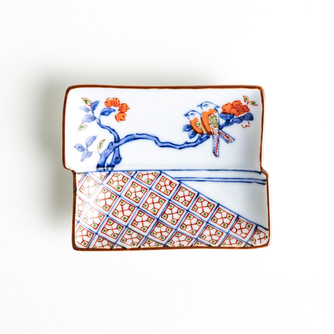 Rectangular plate with an orange bird design and geometric patterns.