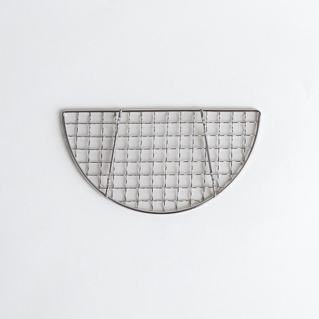 A semi-circular metal grilling rack, featuring a mesh pattern and designed to fit over a heat source for cooking.