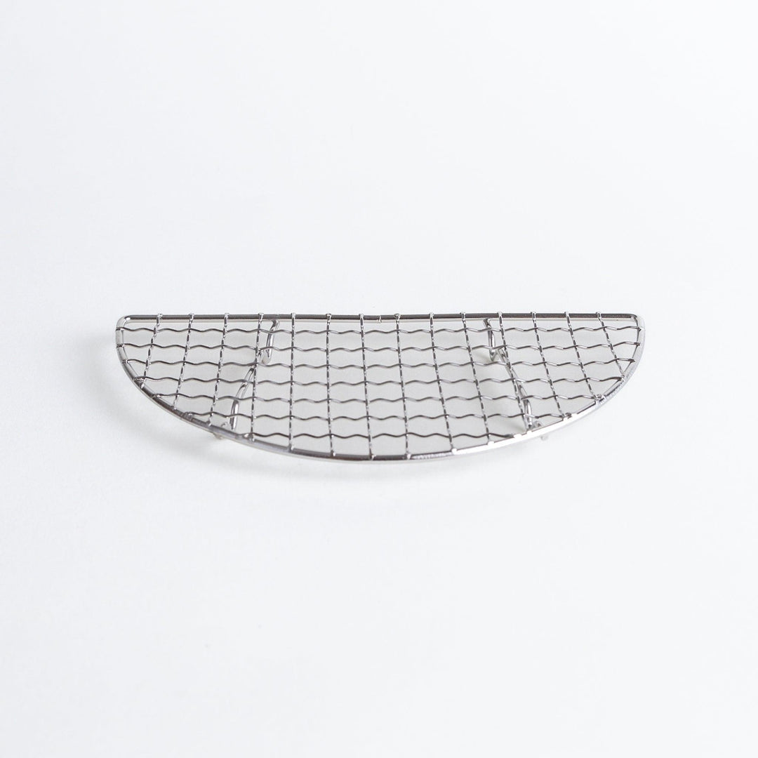 A semi-circular metal grilling rack, featuring a mesh pattern and designed to fit over a heat source for cooking.