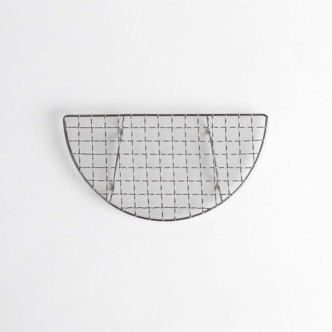 A semi-circular metal grilling rack, featuring a mesh pattern and designed to fit over a heat source for cooking.