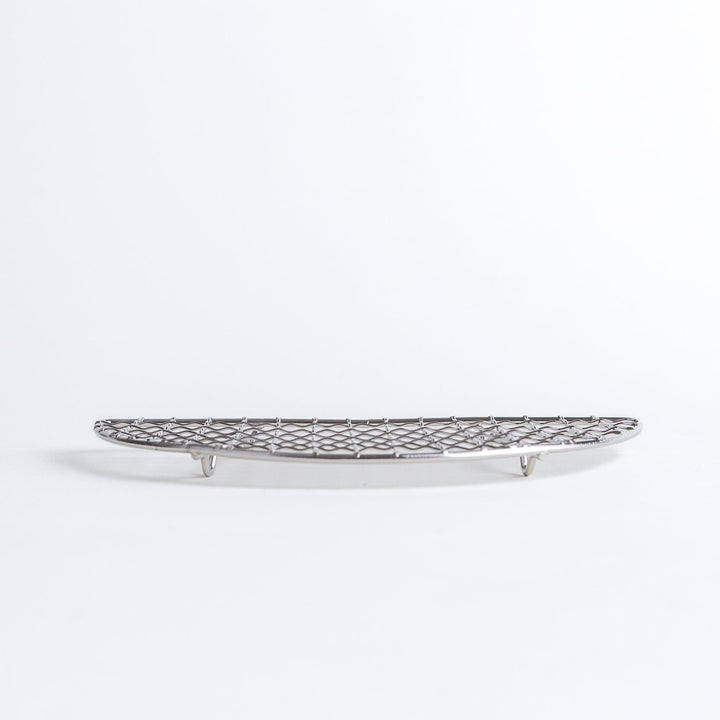 A semi-circular metal grilling rack, featuring a mesh pattern and designed to fit over a heat source for cooking.