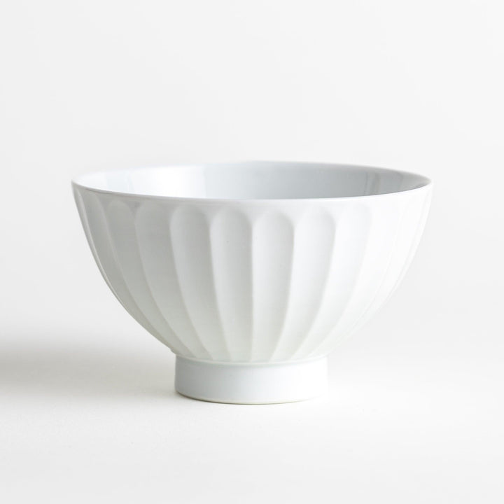 A white ceramic bowl with a bamboo-inspired carved design.