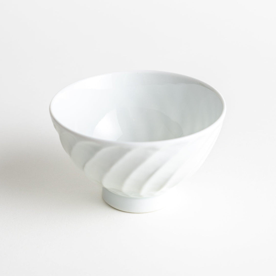 A white ceramic bowl with a subtle wavy carved design.