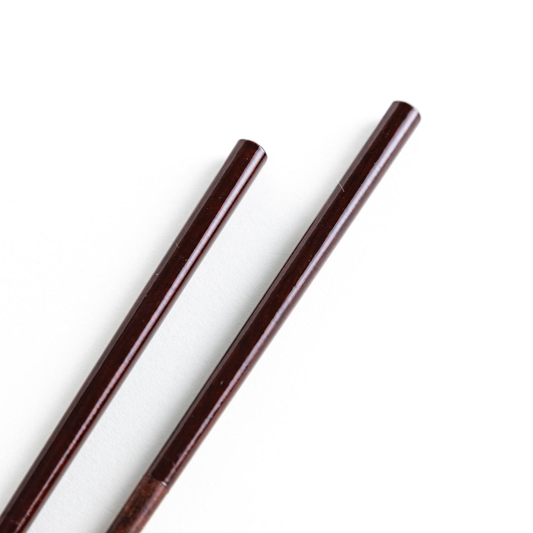 Chopsticks in different colors—white, yellow, olive green, navy blue, and dark brown—with wooden lower halves.