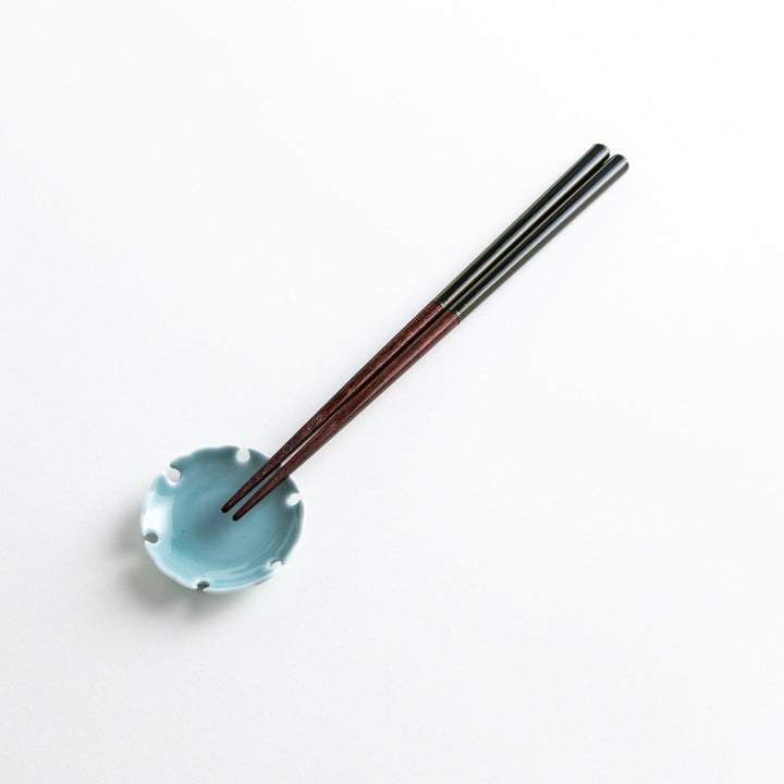 Chopsticks in different colors—white, yellow, olive green, navy blue, and dark brown—with wooden lower halves.