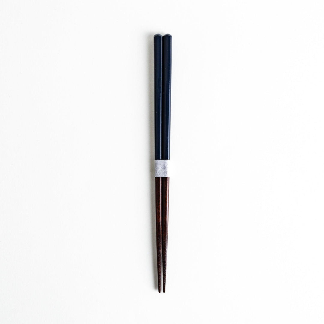 Chopsticks in different colors—white, yellow, olive green, navy blue, and dark brown—with wooden lower halves.