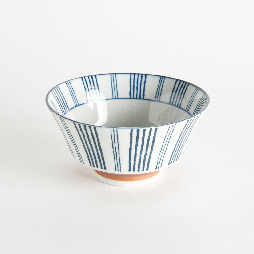 Ceramic ramen bowl with blue striped pattern on white background.