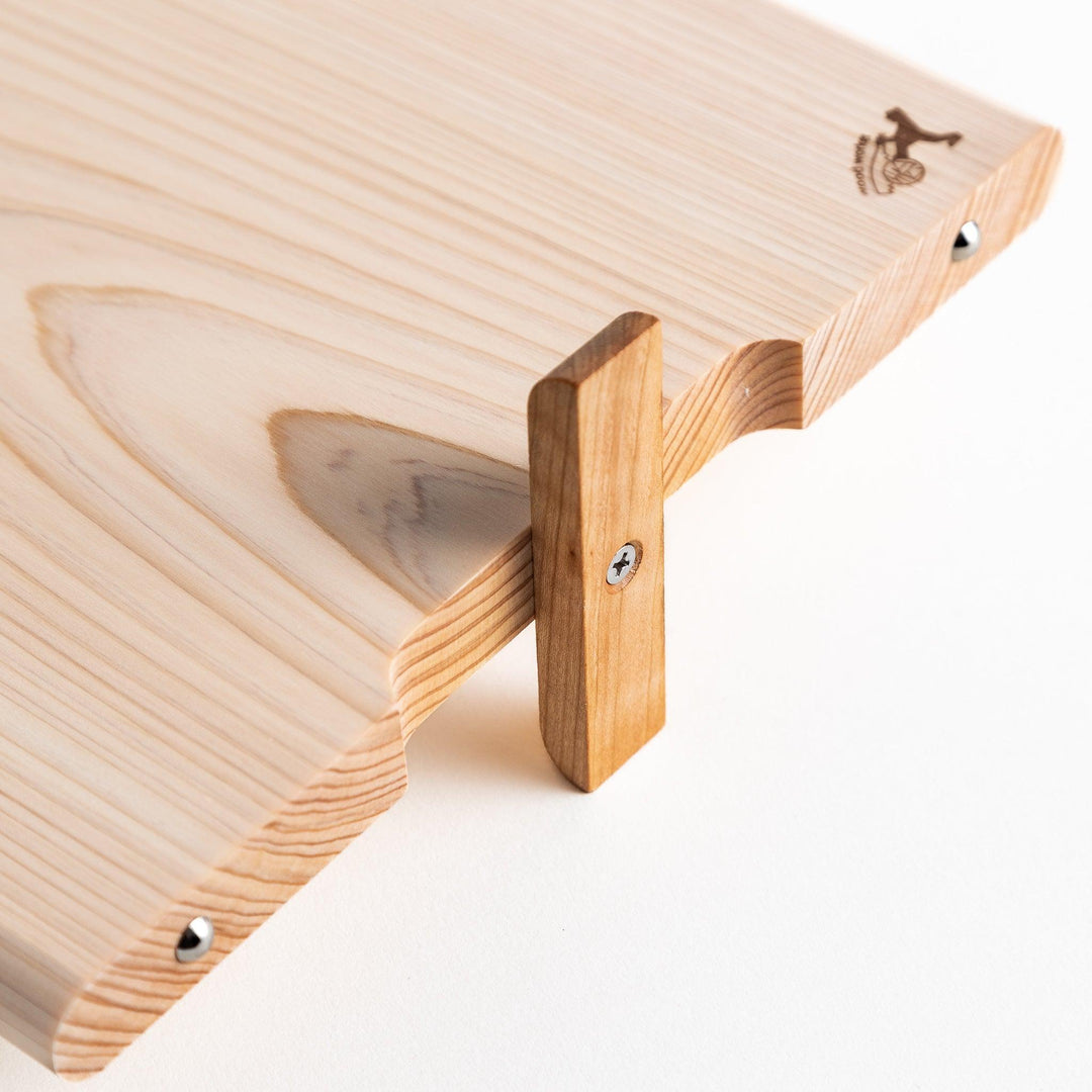 A rectangular hinoki cutting board with a twisting stand.