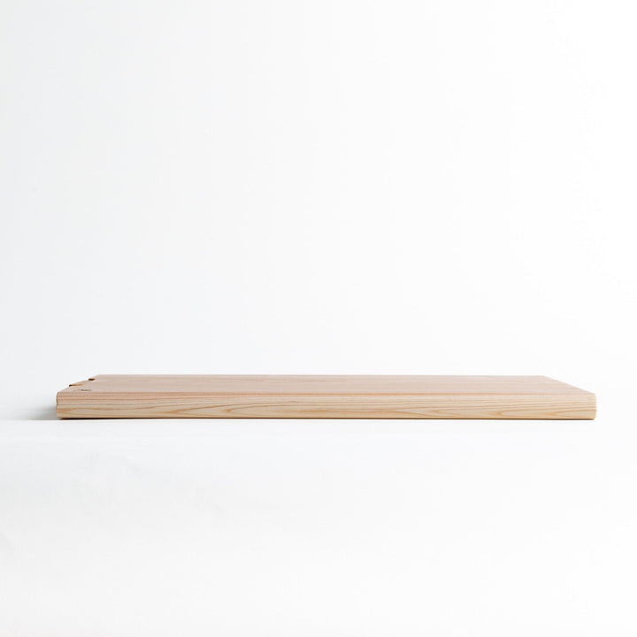 A rectangular hinoki cutting board with a twisting stand.