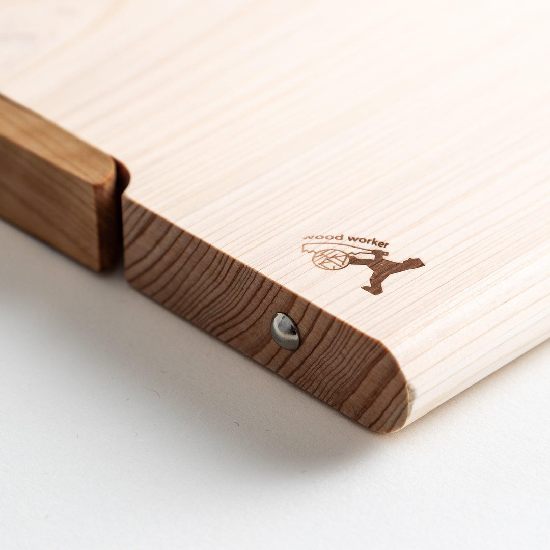 A rectangular hinoki cutting board with a twisting stand.