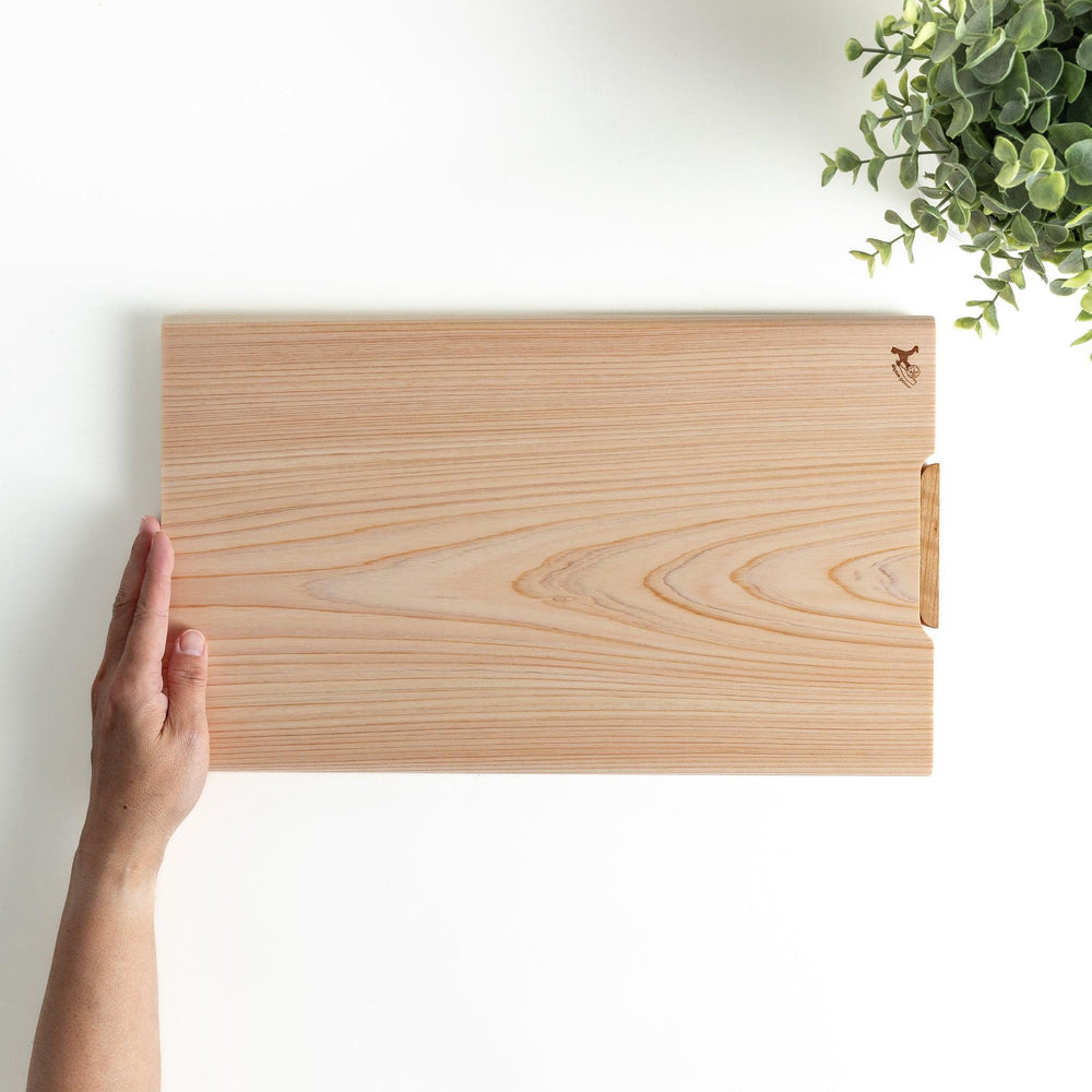 A rectangular hinoki cutting board with a twisting stand.