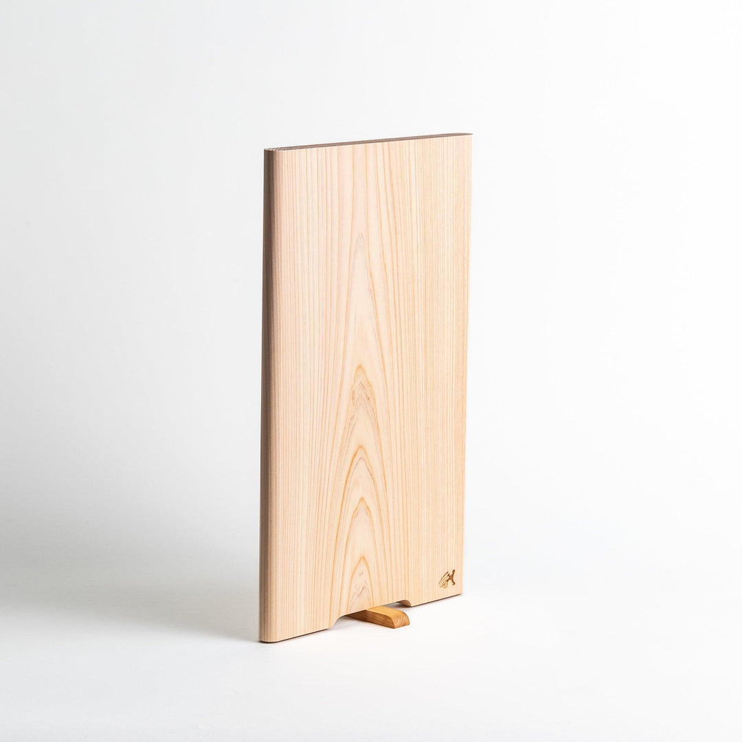 A rectangular hinoki cutting board with a twisting stand.