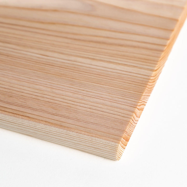 A rectangular hinoki cutting board with a twisting stand.