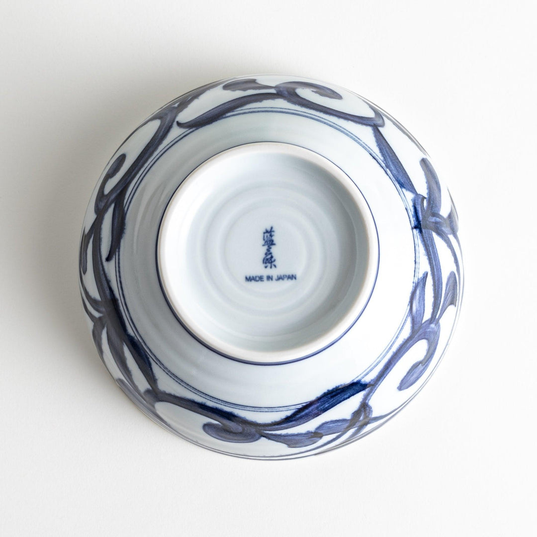 A bowl with a bold blue swirl pattern on a white background.