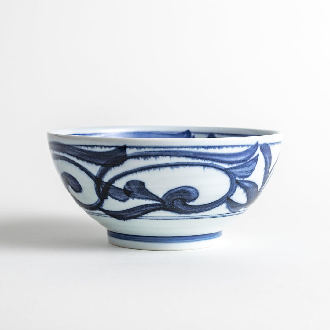 A bowl with a bold blue swirl pattern on a white background.