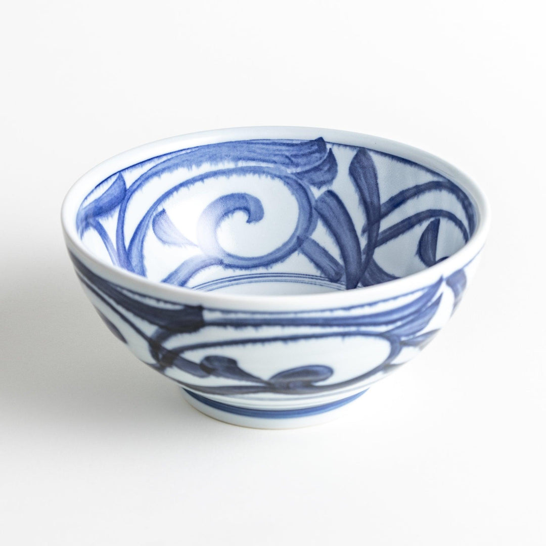 A bowl with a bold blue swirl pattern on a white background.