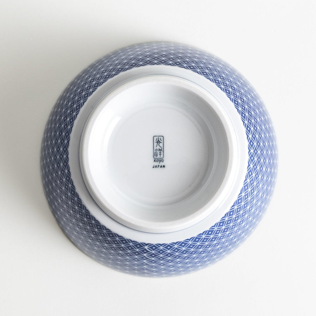 A bowl with a blue geometric diamond pattern on the exterior and a white interior.