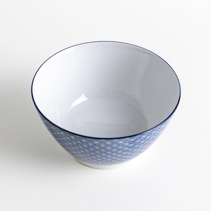 A bowl with a blue geometric diamond pattern on the exterior and a white interior.