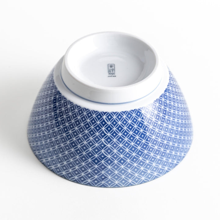 A bowl with a blue geometric diamond pattern on the exterior and a white interior.