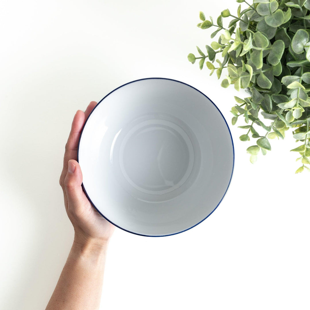 A bowl with a blue geometric diamond pattern on the exterior and a white interior.