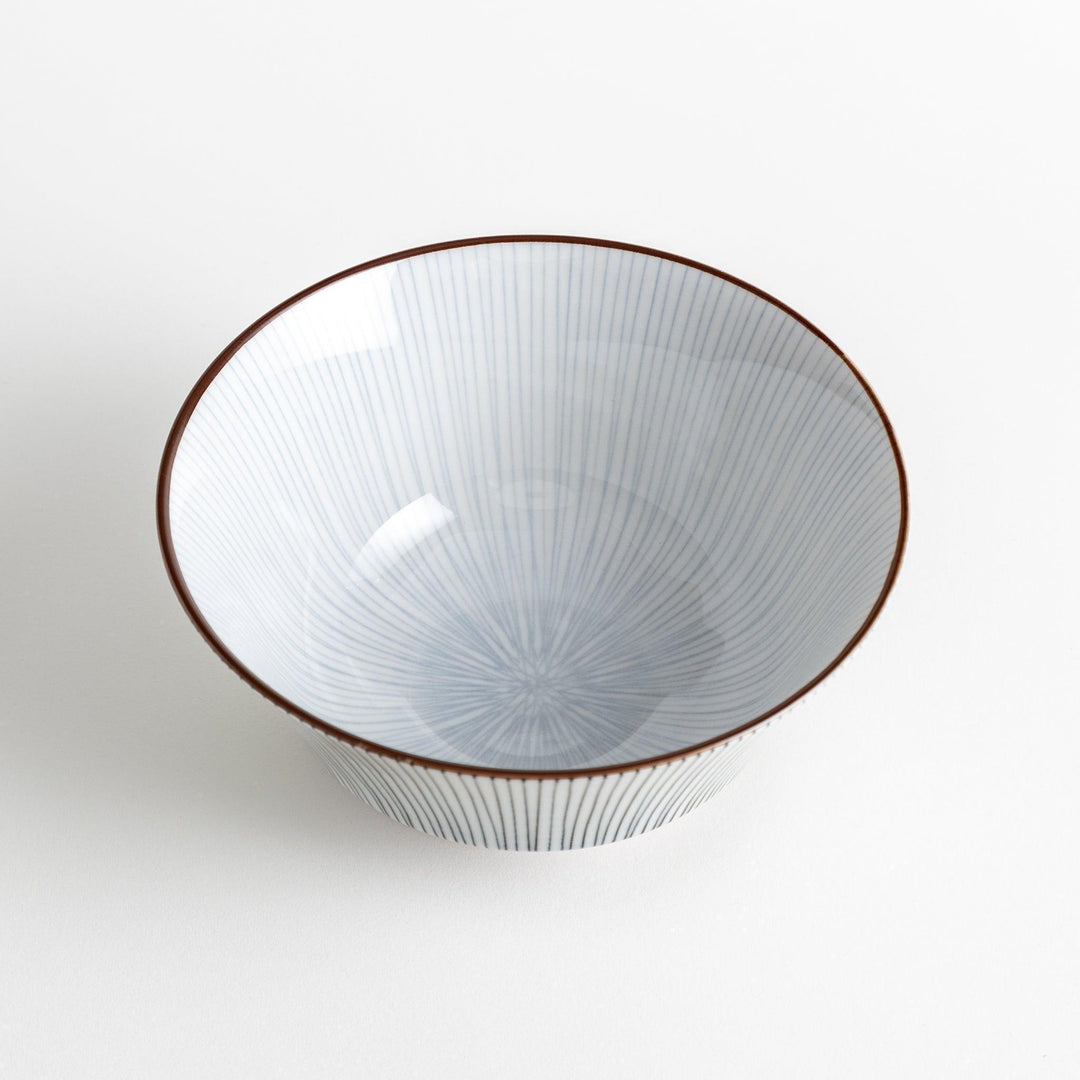 A white bowl with fine, vertical brown stripes and a brown rim, offering a sleek and modern design.