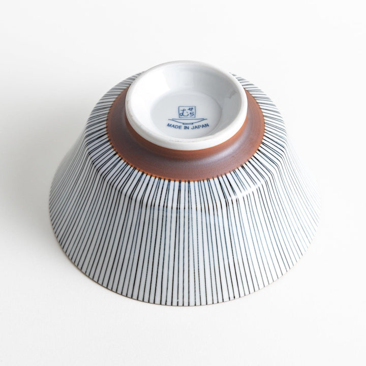 A white bowl with fine, vertical brown stripes and a brown rim, offering a sleek and modern design.