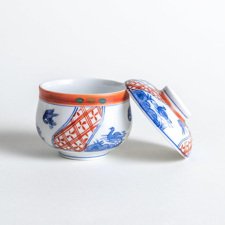 White ceramic cup with saucer, blue and orange floral design