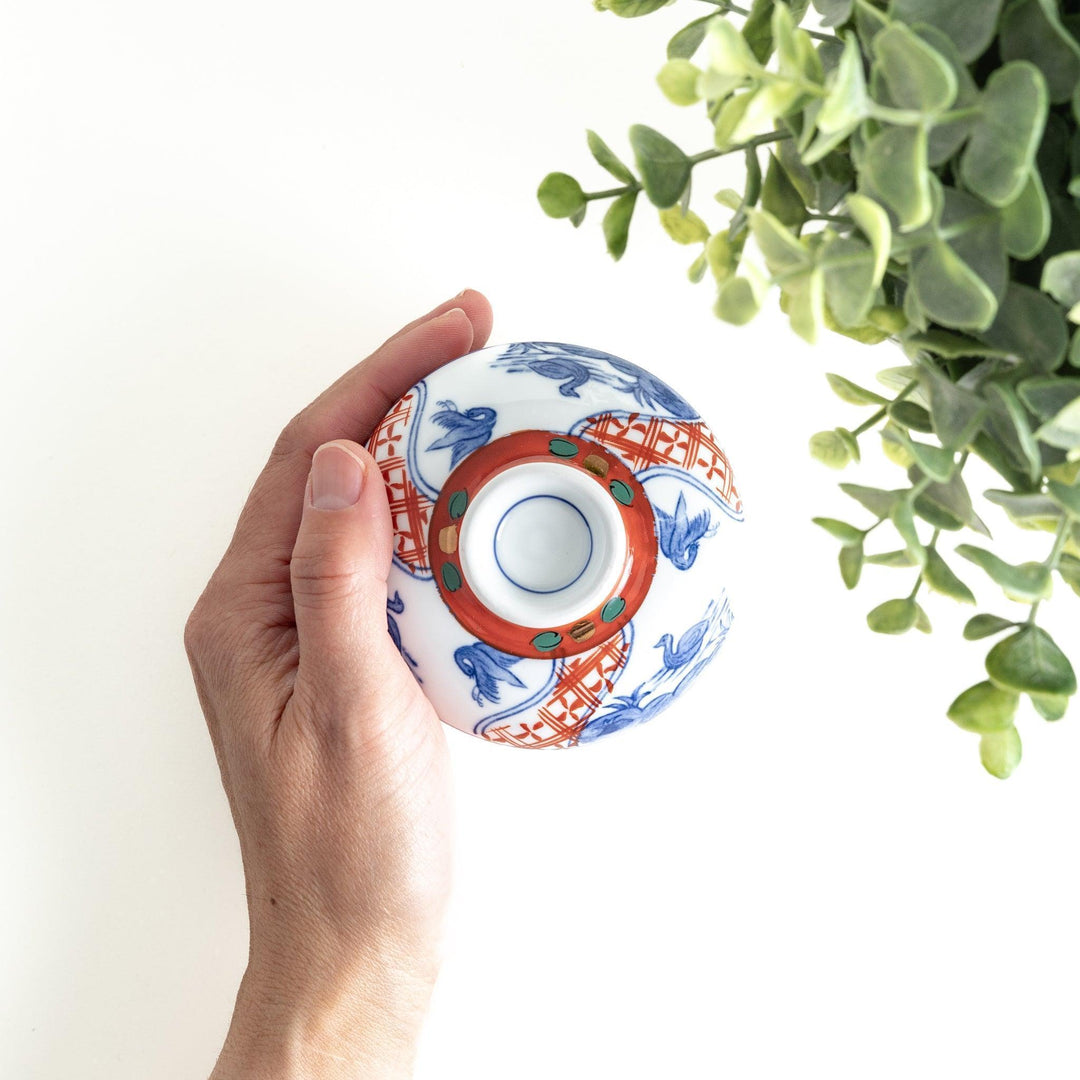 White ceramic cup with saucer, blue and orange floral design