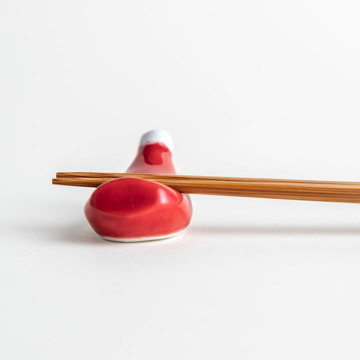 A ceramic chopstick rest resembling a ketchup bottle.