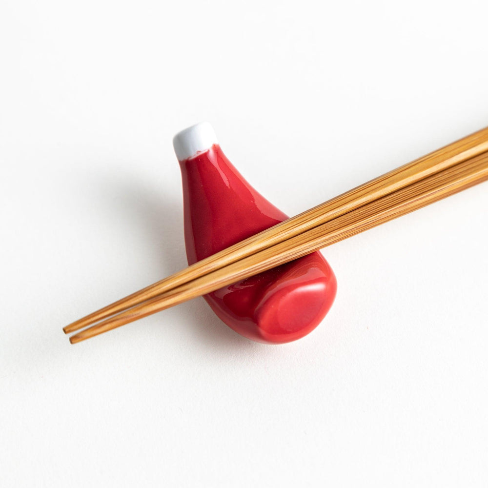 A ceramic chopstick rest resembling a ketchup bottle.